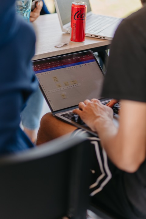 A Bejamas teammate working on a laptop at the retreat